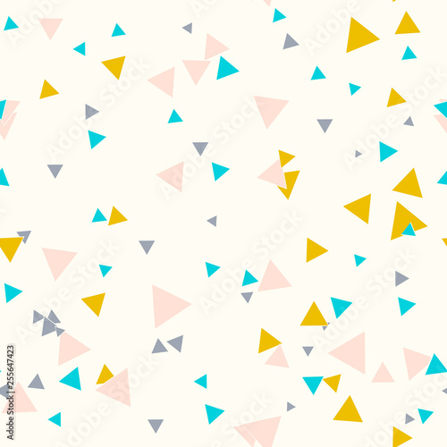 Colorful messy seamless pattern with yellow, blue, gray, pink triangles on beige. Abstract chaotic geometric. Triangular geometrical background. Infinity geometric pattern. Vector illustration.