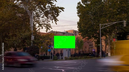 Wallpaper Mural TIME LAPSE video. Advertising billboard with green screen in the center of the autumn cityscape with blurred walking people and cars. Camera moves away Torontodigital.ca