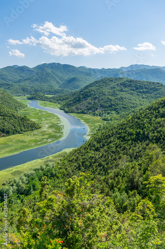 The picturesque meandering river flows among green mountains. © Sergej Ljashenko