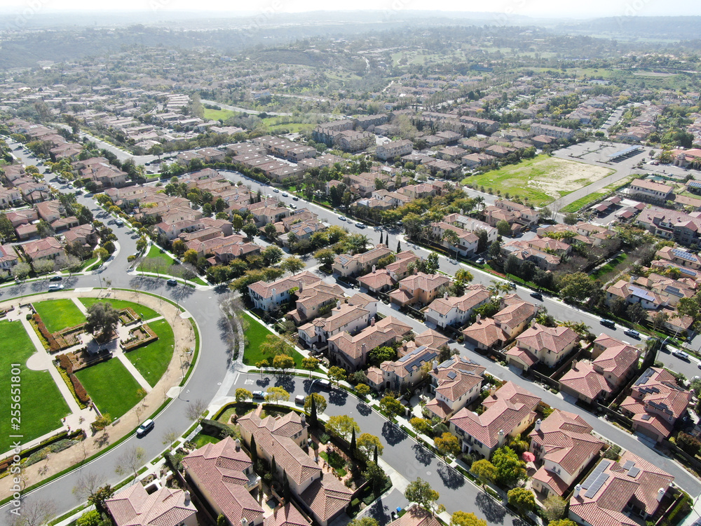 Aerial view suburban neighborhood with identical wealthy villas next to each other. San Diego, California, USA. Aerial view of residential modern subdivision luxury house with swimming pool.