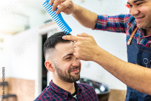 Young Man Getting a Hairstyle in a Barbershop.