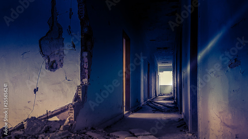 Doorway with bright light in an abandoned building