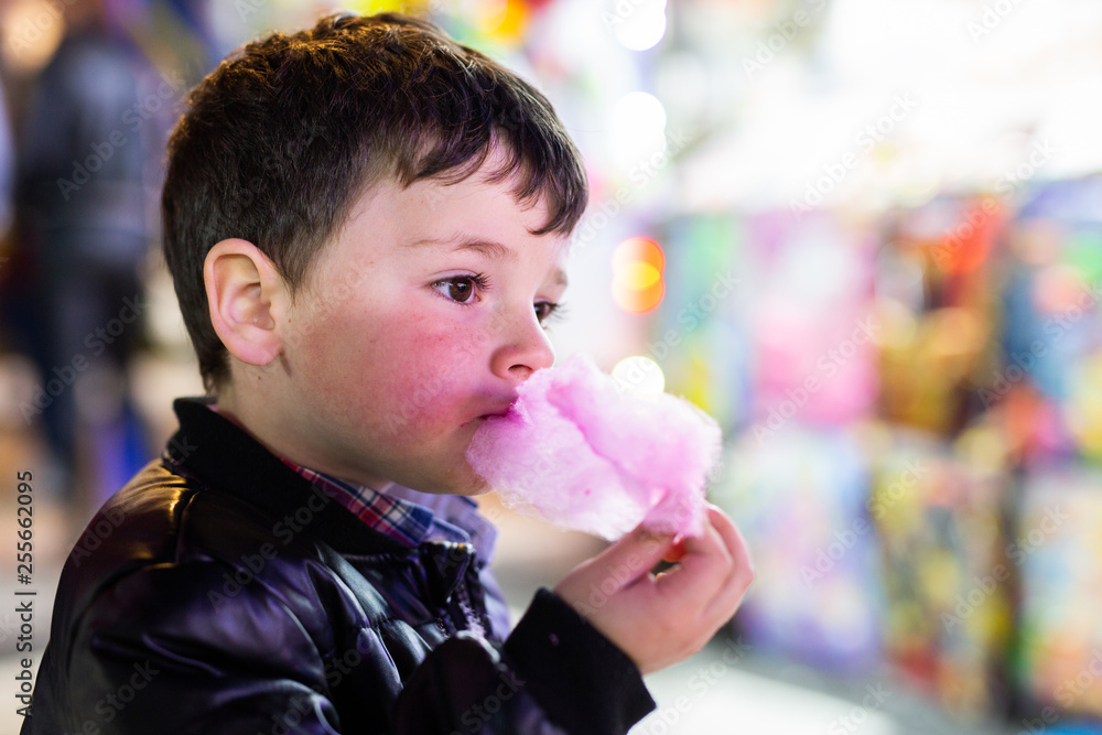boy eats cotton candy at the fair boy eats cotton candy at the fair