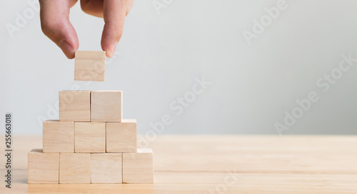 Obraz na plátně Hand arranging wood block stacking as step stair