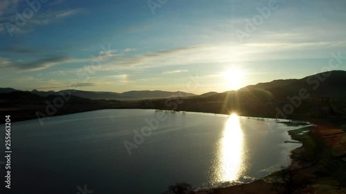 Wallpaper Mural Bright Setting Sun Reflecting on Calm Blue Lake, Aerial Pull Back Torontodigital.ca