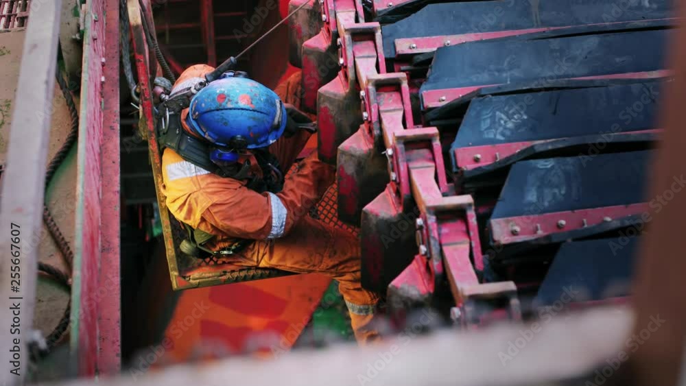 Offshore oil worker doing maintenance.