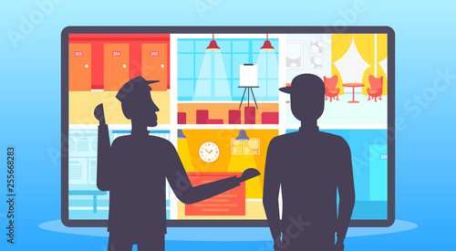 Two security guards looking monitor screen men