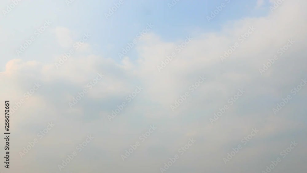 Time lapse locked shot of floating hazy white cumulus clouds on blue sunny sky Time lapse locked shot of floating hazy white cumulus clouds on blue sunny sky