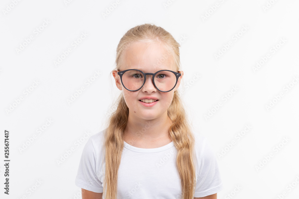 Beautiful child girl with glasses isolated on white