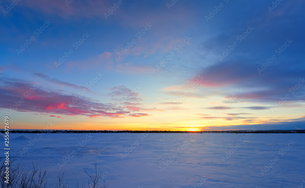 Beautiful Sunset and Pink clouds over frozen lake
