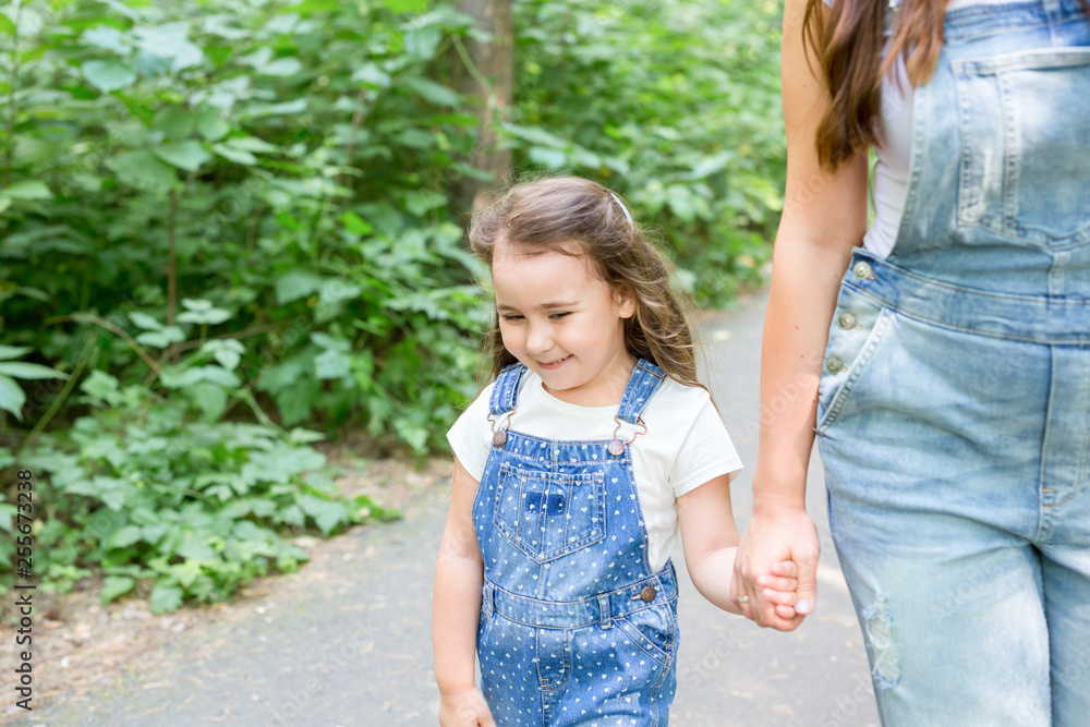 Family, nature and people concept - Mom and baby daughter spend time together on a walk in the green park Family, nature and people concept - Mom and baby daughter spend time together on a walk in the green park