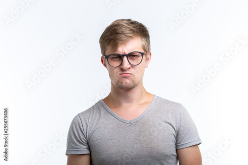 People and emotions concept - Unhappy funny man isolated over white background © satura_