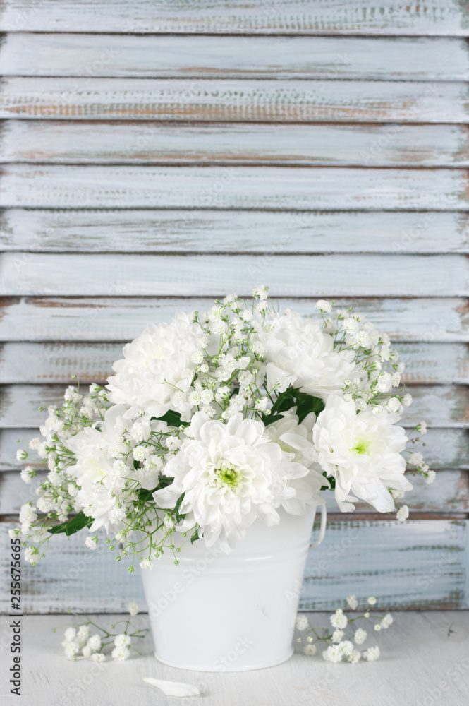 White flowers bouquet against wooden shutters White flowers bouquet against wooden shutters