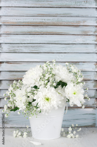 White flowers bouquet against wooden shutters © Svetlana Lukienko