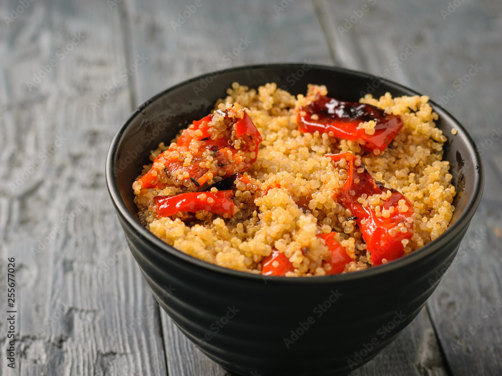 Boiled quinoa with baked bell pepper on the table. Vegetarian dish. Boiled quinoa with baked bell pepper on the table. Vegetarian dish.