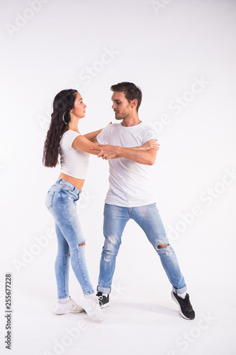 Passionate couple dancing social danse kizomba or bachata or semba or taraxia on white background