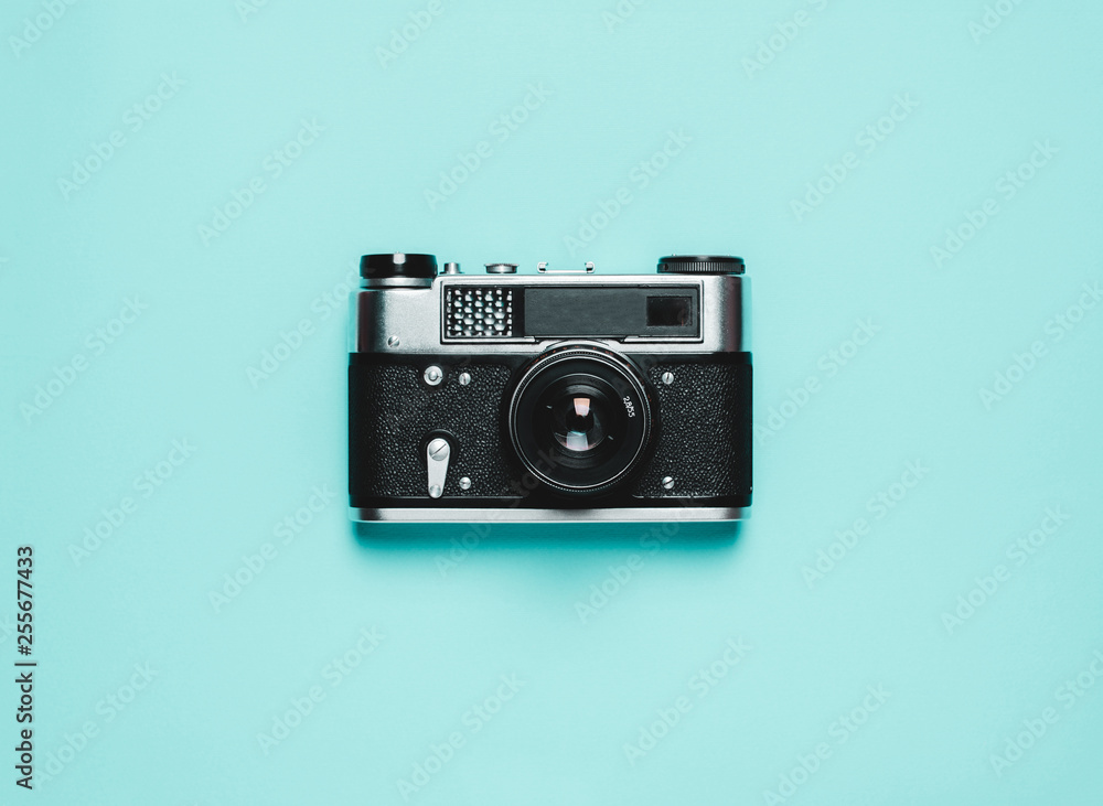 old Vintage photo camera on a blue background