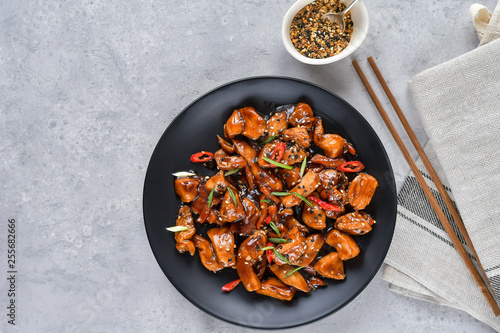 Photos spicy chicken in sweet and sour sauce with chili pepper