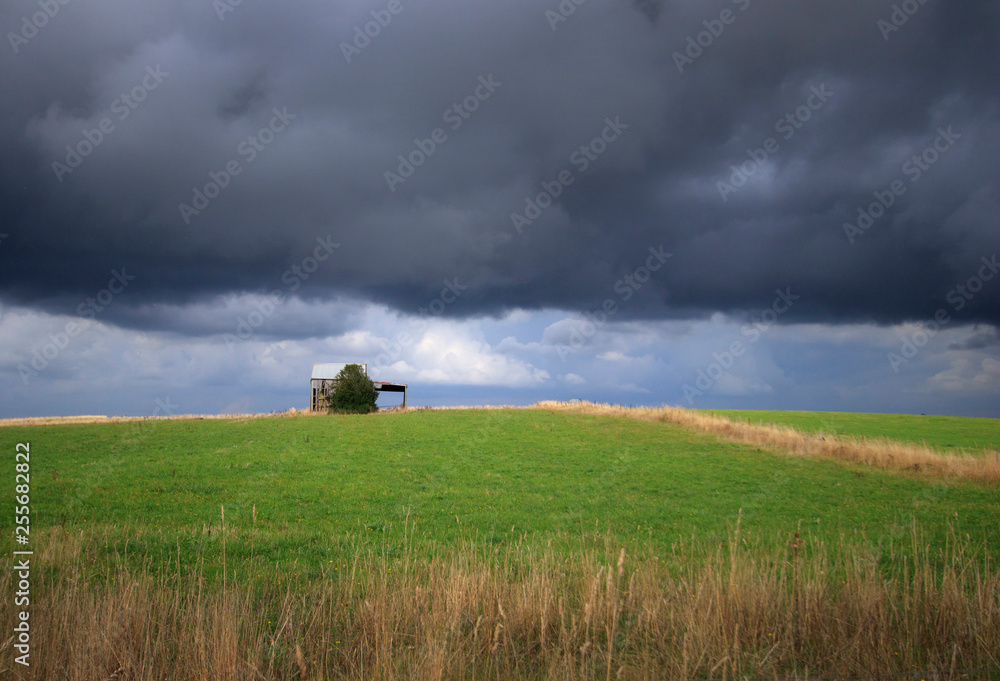 Fototapeta premium Storm clouds over country farm paddock