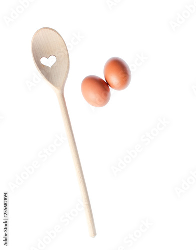 eggs and wooden spoon isolated on white background © splitov27