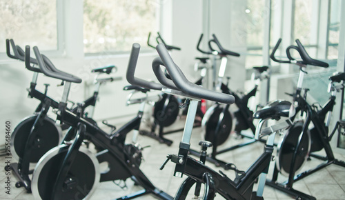 Healthy lifestyle concept. Lot of exercise bicycle in empty hall spinning class.