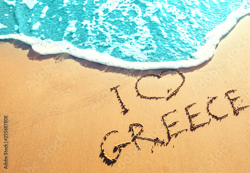 Golden sandy beach with the inscription on the sand by the sea - I love Greece. Best beaches in Europe