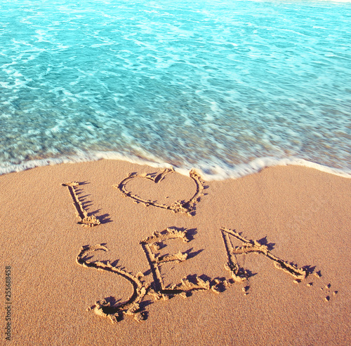 Beach sand, sea and the inscription - I love sea. Best holidays concept © millaf