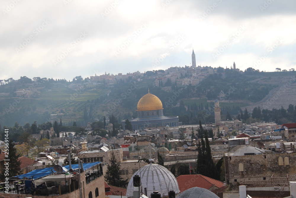 Naklejka premium Sky over Jerusalem old town. View on the Jerusalem old town from the rooftop in the early morning