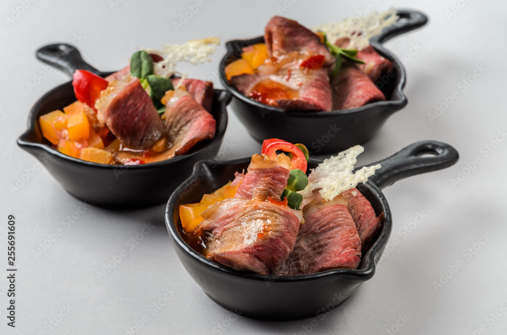 Duck breast with mango chutney in small pans Duck breast with mango chutney in small pans