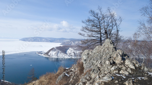View of the source of the Angara river from lake Baikal from the observation deck at the stone Chersky. A journey to Siberia for the winter Baikal. Holidays in Russia photo