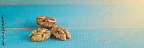 Walnut kernels on a blue wooden background.