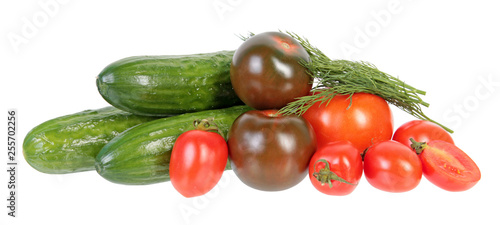 Fresh green cucumbers, different red tomatoes and bundle of green dill leaves isolated on white background. Ingredients for vegetable salad