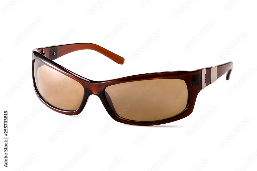 Stylish women's brown sunglasses on a white background. In half a turn. Stylish women's brown sunglasses on a white background. In half a turn.