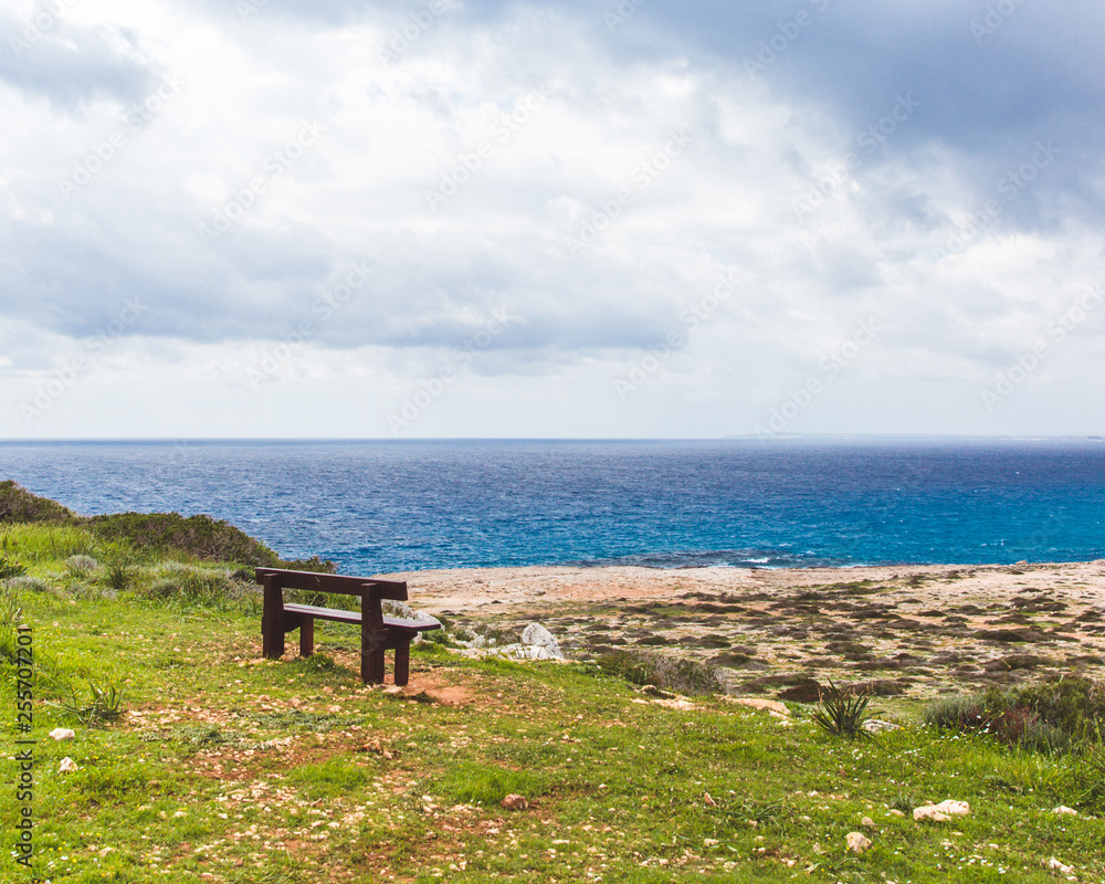 Bench stands on the seashore. Beautiful valley by the sea. Seascape in Cyprus Ayia Napa