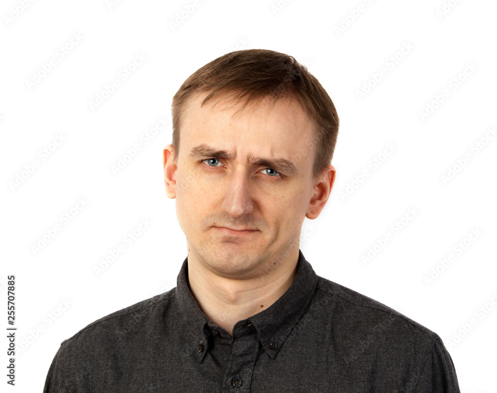 A young man looks skeptical at the interlocutor. Concept emotions skepticism A young man looks skeptical at the interlocutor. Concept emotions skepticism