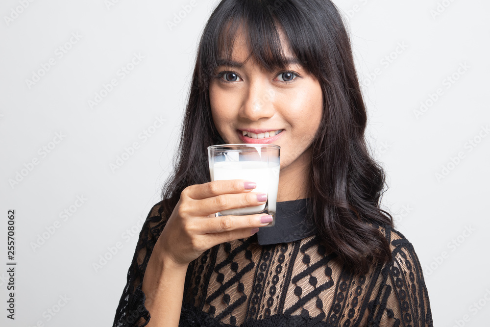 Healthy Asian woman drinking a glass of milk. Healthy Asian woman drinking a glass of milk.