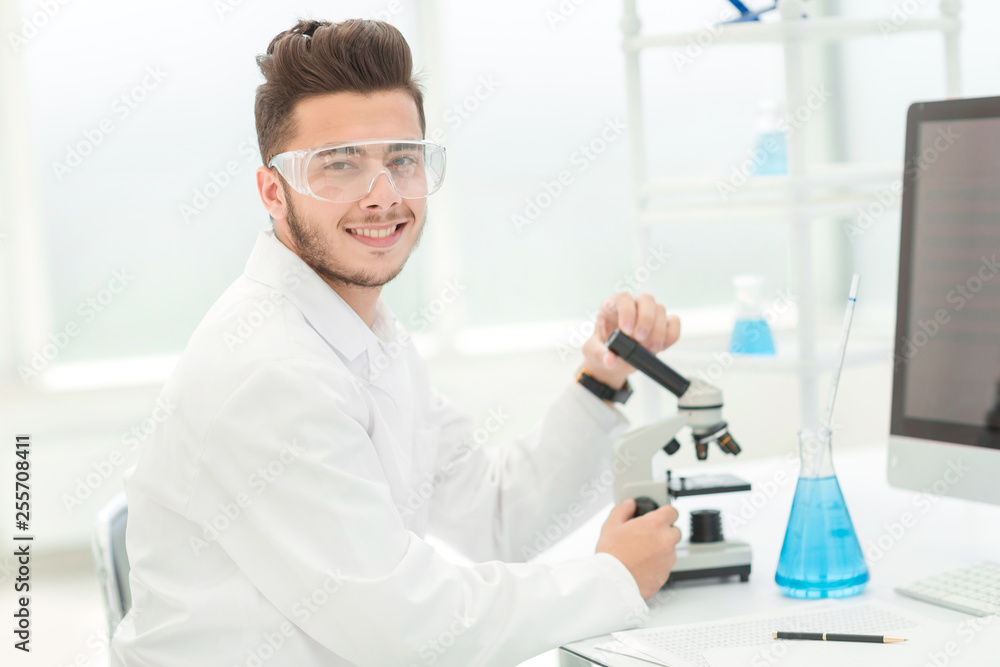 modern scientist sitting at his Desk in the laboratory