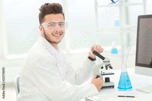 modern scientist sitting at his Desk in the laboratory