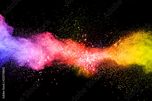 Launched colorful powder on black background.Color powder explosion.Colorful dust splashing.