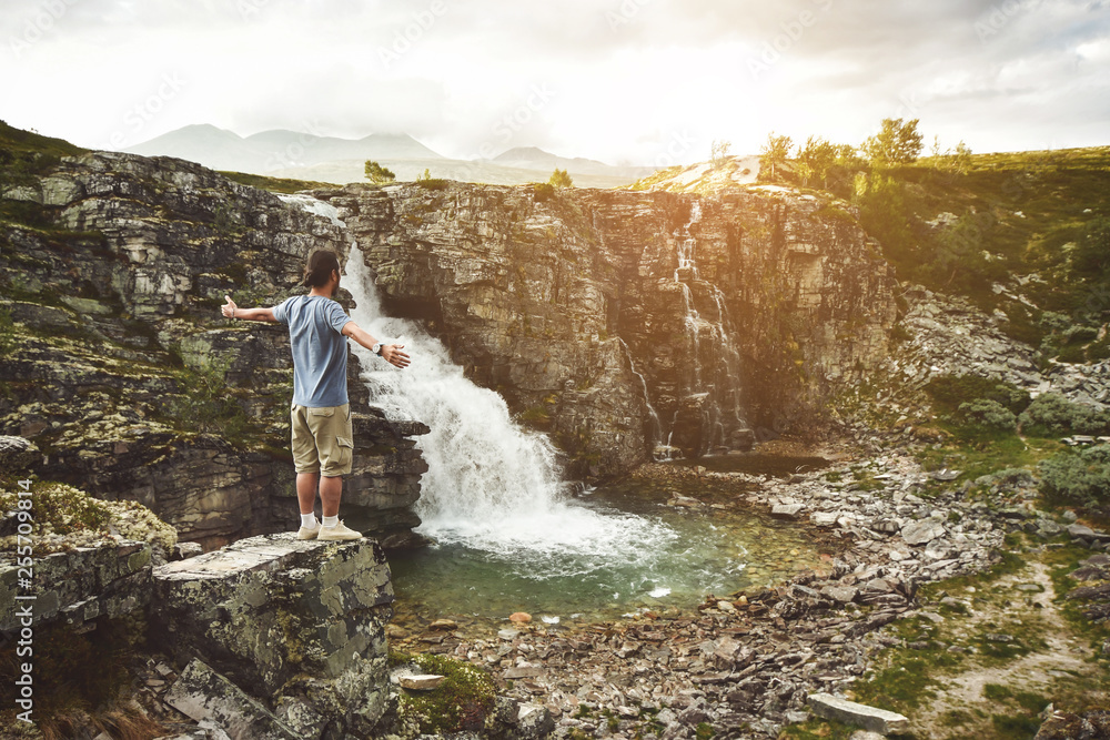 Man on a cliff at storulfossen Norway Man on a cliff at storulfossen Norway