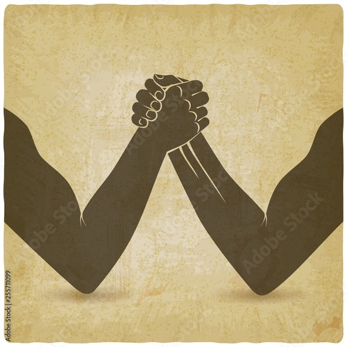 Arm wrestling. Two men hands shaking silhouette vintage background
