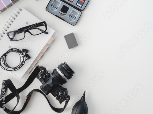 top view of work space photographer with digital camera, flash, cleaning kit, white table background. photo