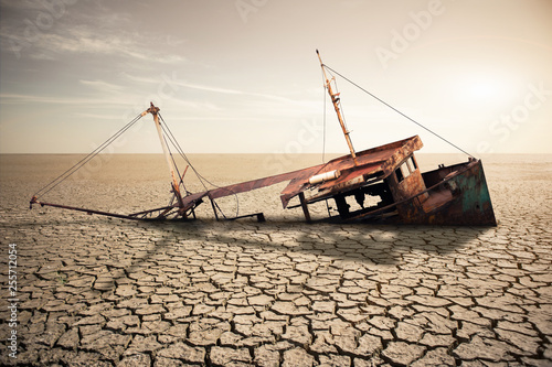 Fotografie Rusty ship in a dried ocean