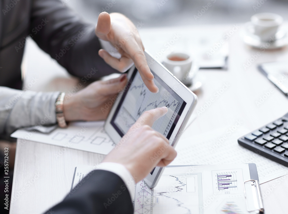 close up.Business adviser analyzing financial figures denoting the progress in the company close up.Business adviser analyzing financial figures denoting the progress in the company