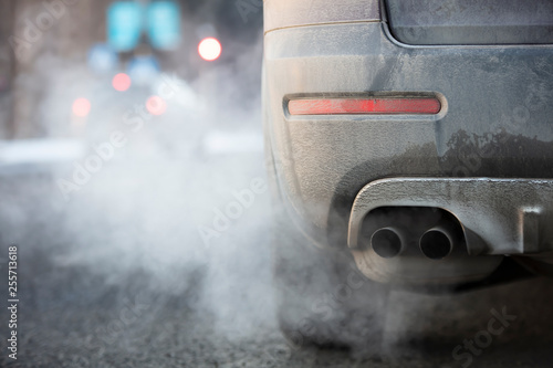Car exhaust pipe, which comes out strongly exhaust gases in Finland. It is winter and the car is very dirty. photo