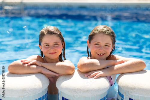 Two cute gils in swimming pool