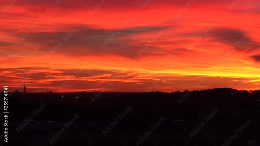 A red sunset over a dark cityscape A red sunset over a dark cityscape