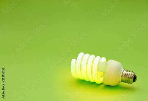 energy saving lightbulb on green background