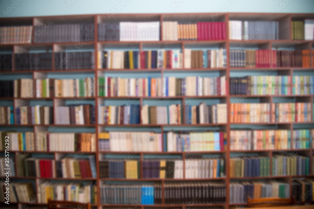 Blurred image of bookshelves in a public library. School library. Education concept Blurred image of bookshelves in a public library. School library. Education concept