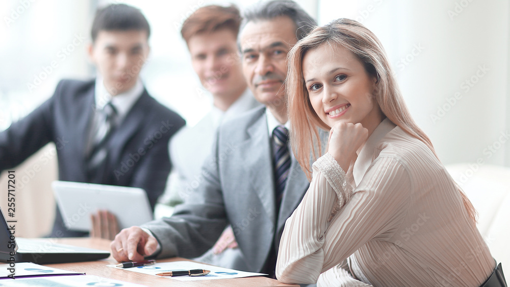 Portrait of mature business man smiling during meeting with colleagues in background Portrait of mature business man smiling during meeting with colleagues in background